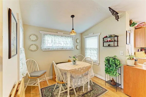 a dining room with furniture a chandelier and wooden floor
