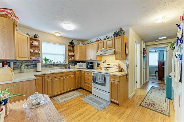 a kitchen with a sink appliances and cabinets