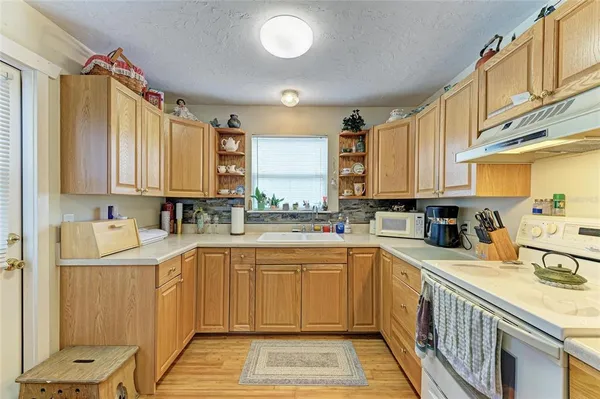 a kitchen with a sink stove and cabinets