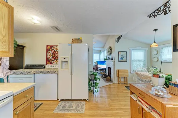 a kitchen with a refrigerator and a stove top oven