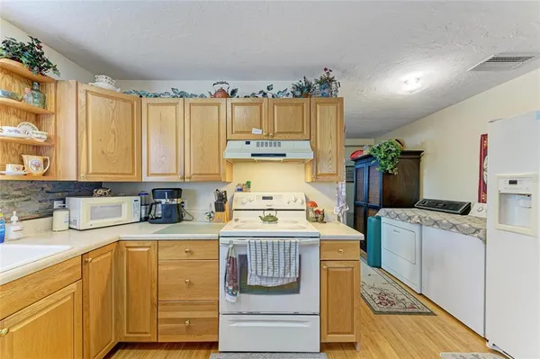 a kitchen with a stove a sink and a refrigerator