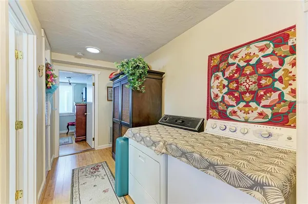 a bedroom with a bed and a painting on the wall
