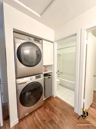 a view of a hallway with washer and dryer
