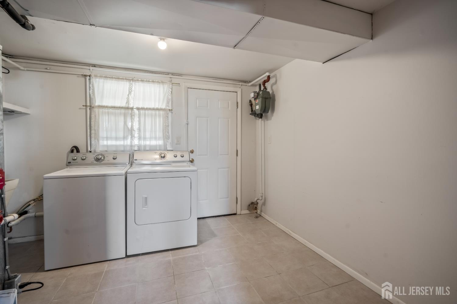8 Tompkins Road East Brunswick, NJ 08816 - Photo 13 of 22 a utility room with cabinets washer and dryer