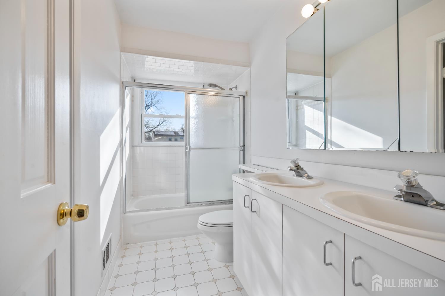 8 Tompkins Road East Brunswick, NJ 08816 - Photo 7 of 22 a bathroom with a sink a toilet and shower