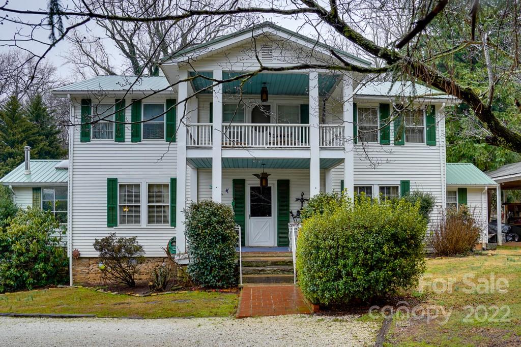 60 Mimosa Inn Drive Tryon, NC 28782 - Photo 1 of 26 a front view of a house with garden