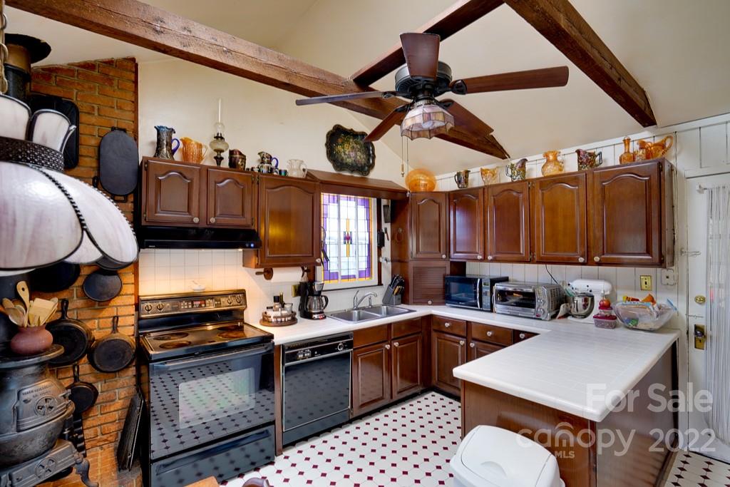 60 Mimosa Inn Drive Tryon, NC 28782 - Photo 12 of 26 a kitchen with a sink cabinets and appliances