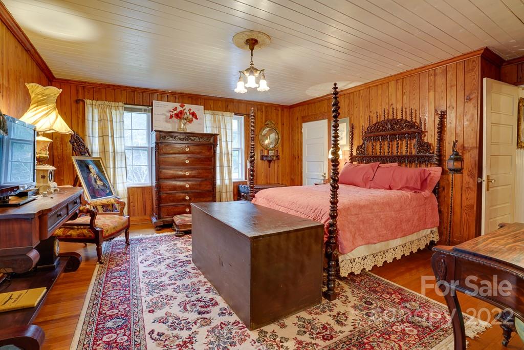 60 Mimosa Inn Drive Tryon, NC 28782 - Photo 18 of 26 a bed room with a bed and a chandelier