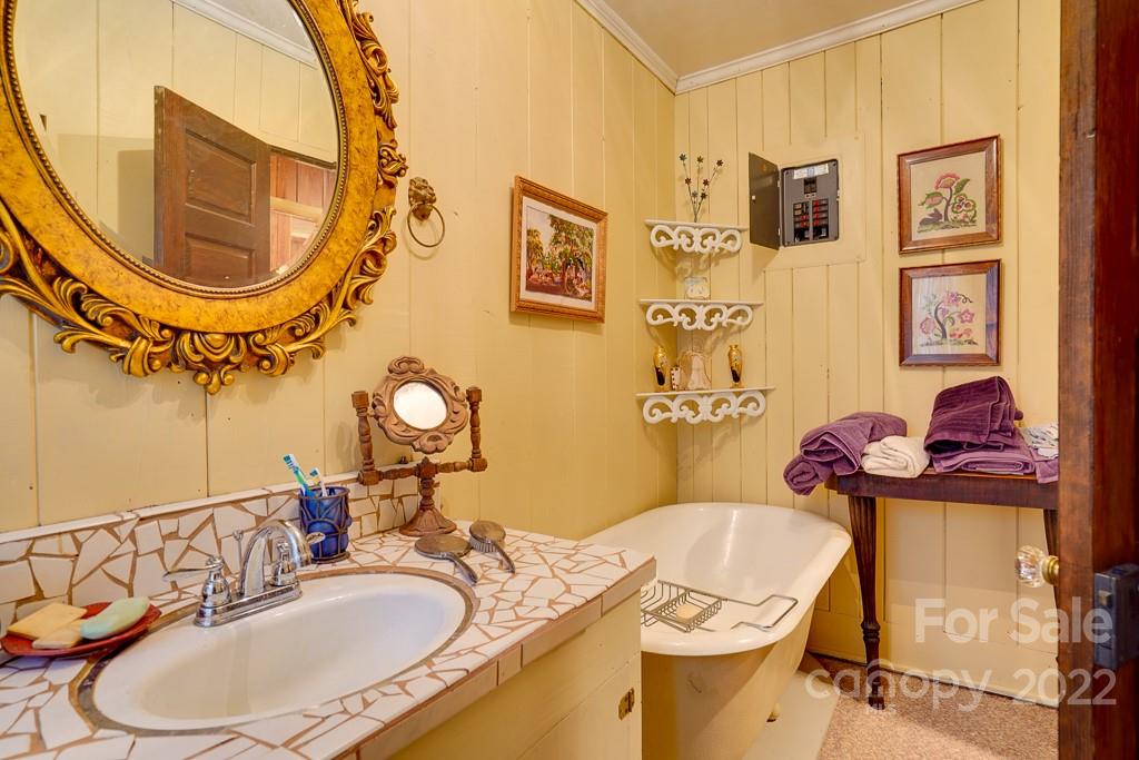 60 Mimosa Inn Drive Tryon, NC 28782 - Photo 24 of 26 a bathroom with a mirror sink and mirror