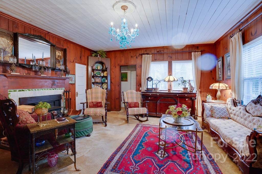 60 Mimosa Inn Drive Tryon, NC 28782 - Photo 4 of 26 a living room with fireplace furniture and a chandelier