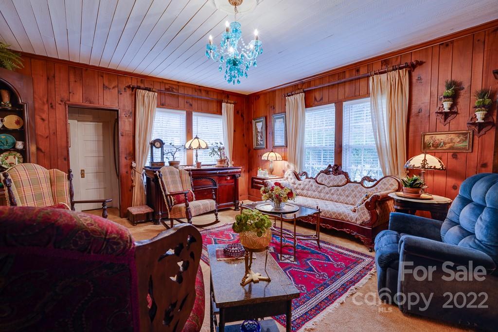 60 Mimosa Inn Drive Tryon, NC 28782 - Photo 6 of 26 a living room with furniture a large window and a chandelier