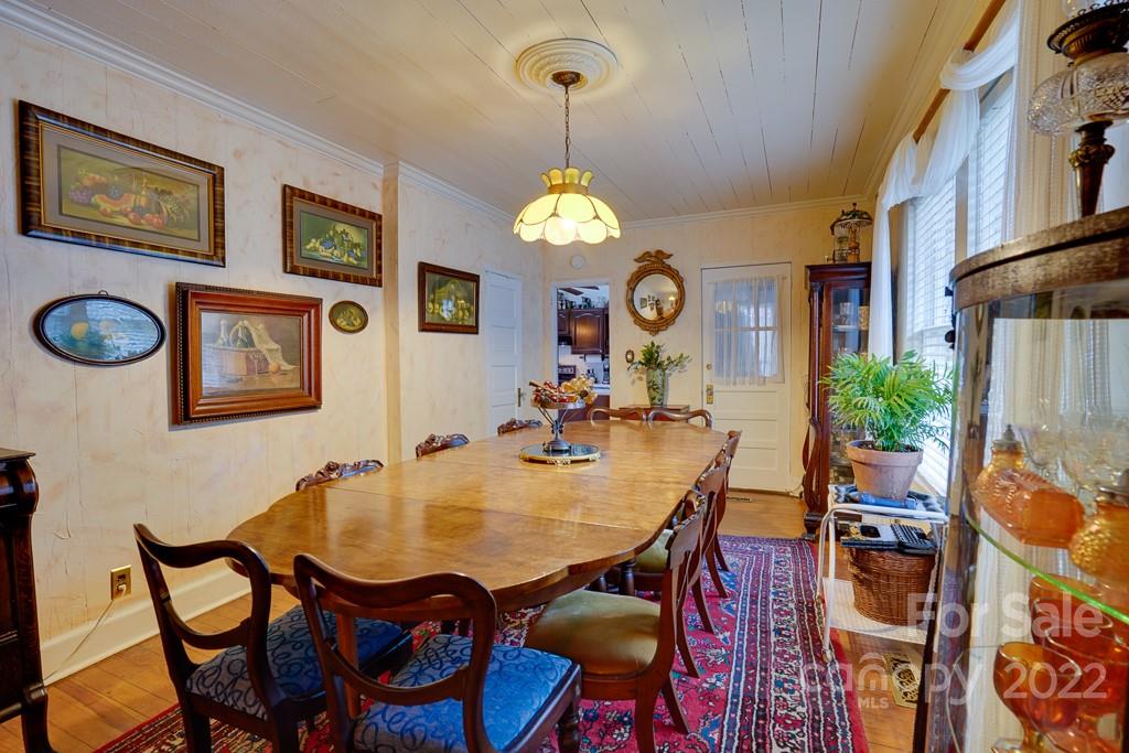 60 Mimosa Inn Drive Tryon, NC 28782 - Photo 9 of 26 a view of a dining room with furniture and a chandelier