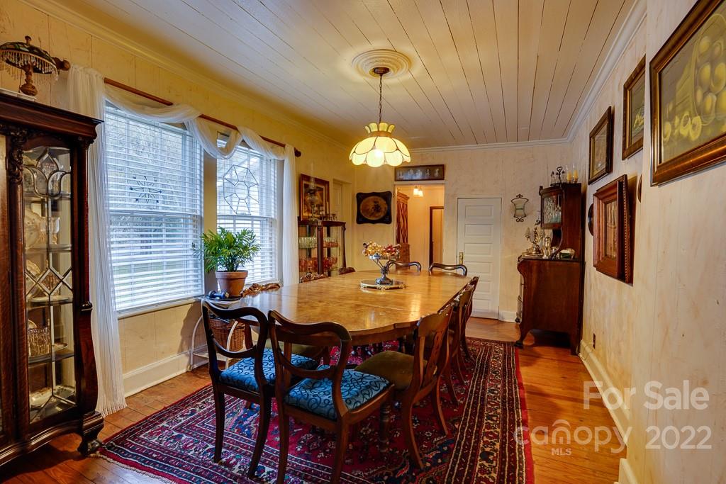60 Mimosa Inn Drive Tryon, NC 28782 - Photo 10 of 26 a view of a dining room with furniture and chandelier
