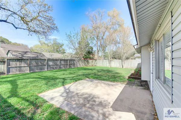 a front view of a house with yard and green space