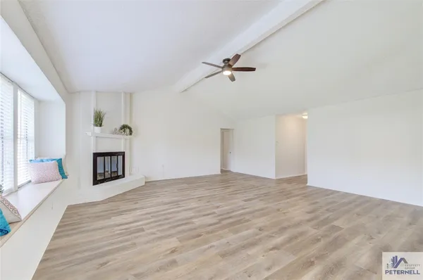 a view of a house with a yard and large tree