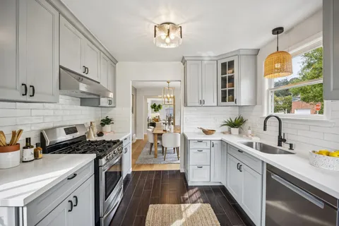 a kitchen with stainless steel appliances a stove a sink and a refrigerator