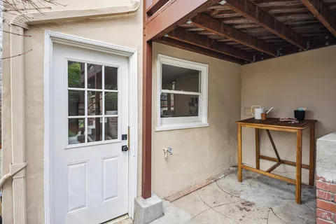 a front view of a house with a garden