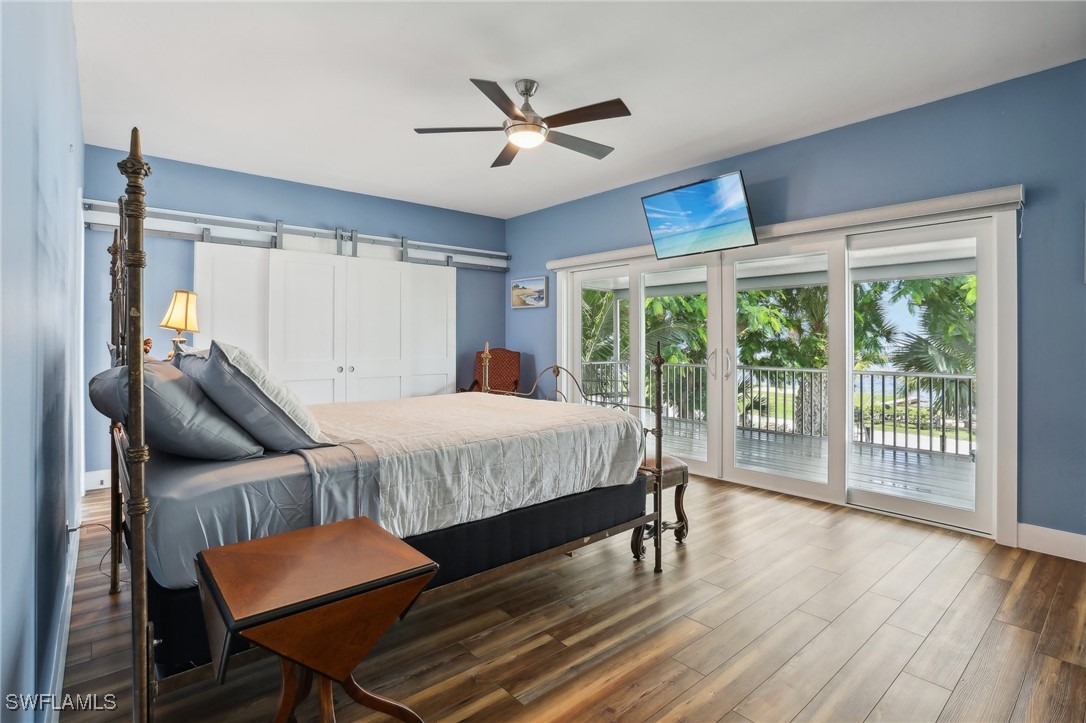 8335 Main Street Bokeelia, FL 33922 - Photo 30 of 47 a bed sitting in a spacious bedroom next to a window