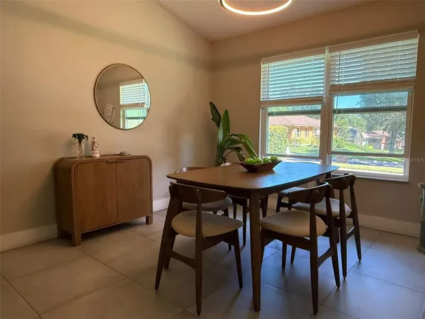 a view of a dining room with furniture and a large window