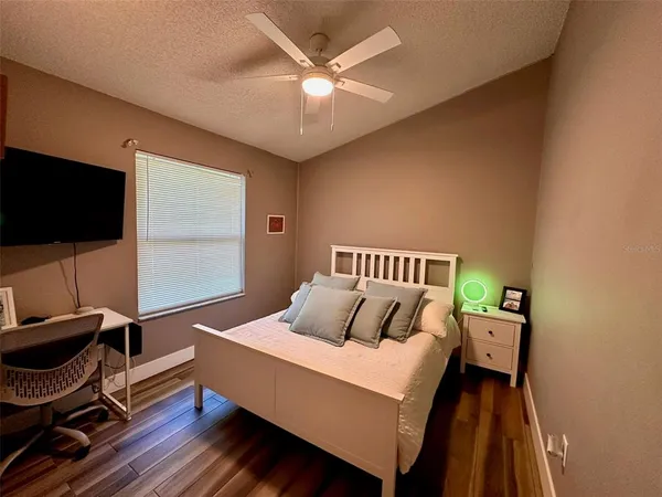 a bedroom with a bed and a desk