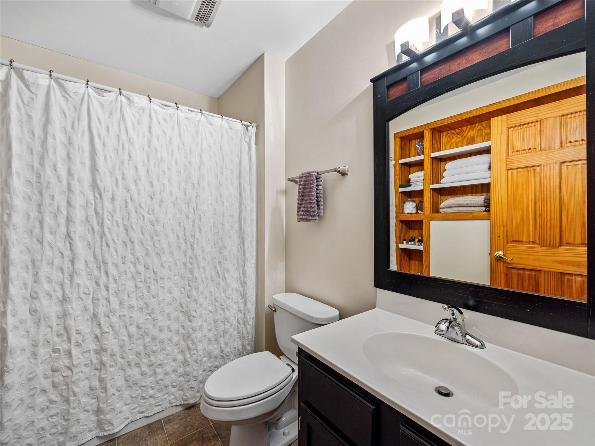 11 Pinewood Road Asheville, NC 28805 - Photo 13 of 31 a bathroom with a sink a toilet and shower curtain