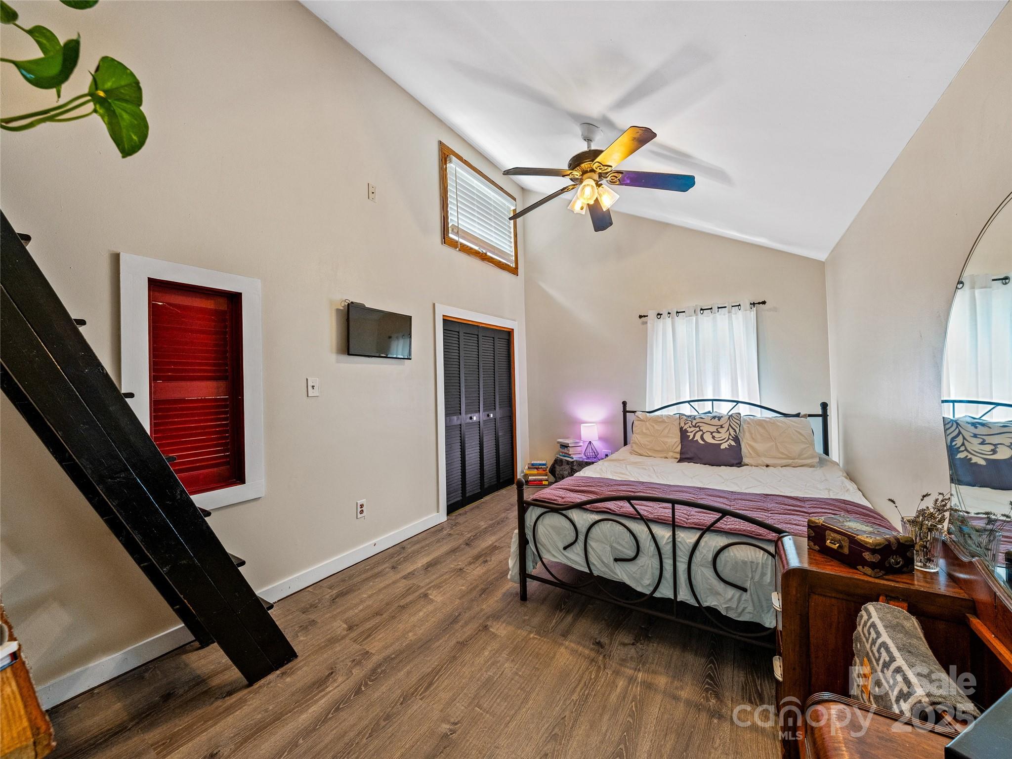 11 Pinewood Road Asheville, NC 28805 - Photo 17 of 31 a bedroom with a bed a chandelier and dresser