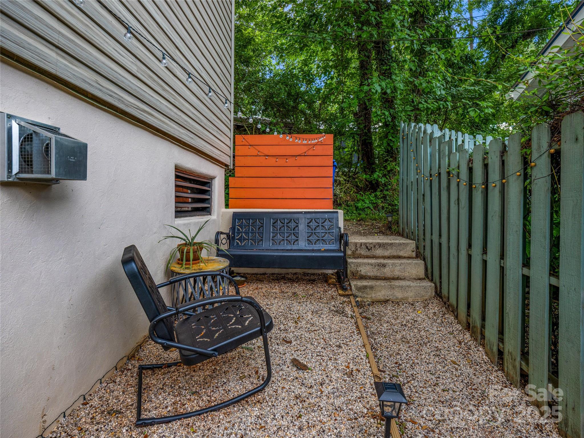 11 Pinewood Road Asheville, NC 28805 - Photo 24 of 31 a backyard of a house with barbeque oven and outdoor seating