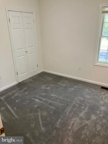 a white toilet sitting next to a bath tub