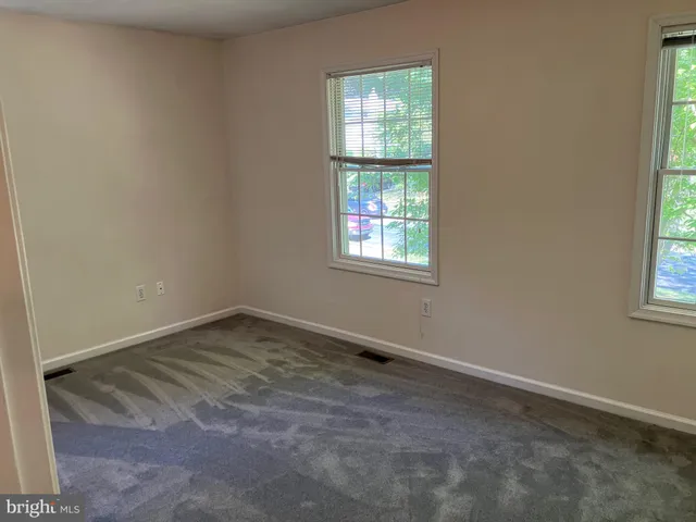 a view of a closet with wooden floor