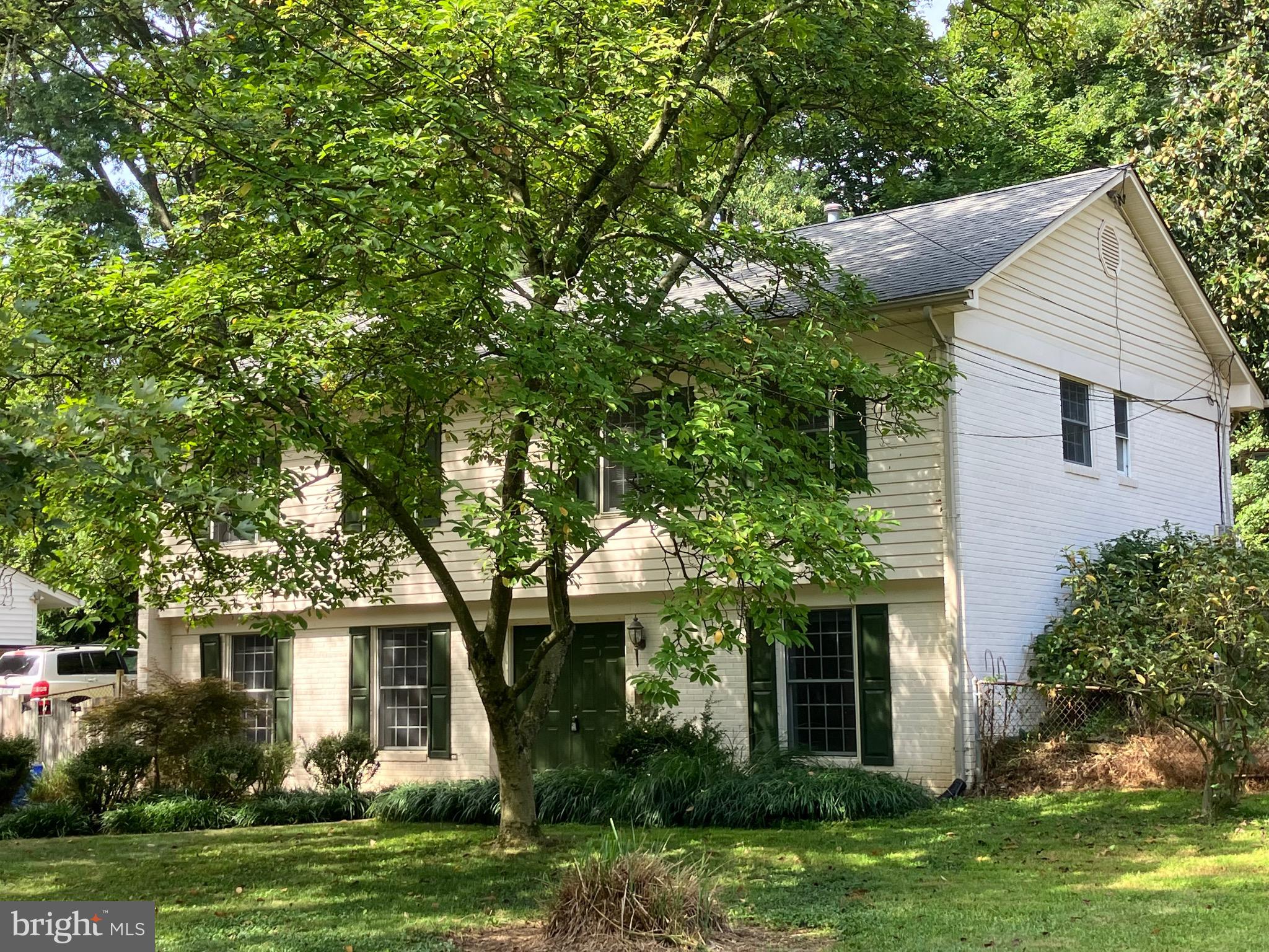 10316 Royal Road Silver Spring, MD 20903 - Photo 4 of 46 a front view of a house with a garden and trees