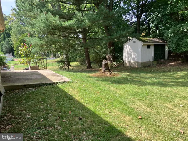 a backyard of a house with garden and barbeque oven