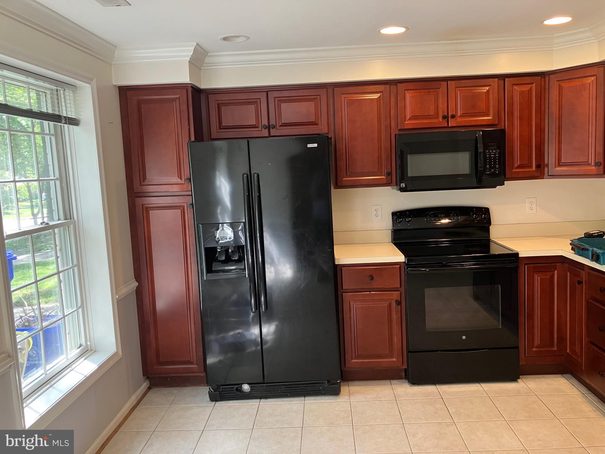 10316 Royal Road Silver Spring, MD 20903 - Photo 8 of 46 a kitchen with stainless steel appliances granite countertop a refrigerator and a sink