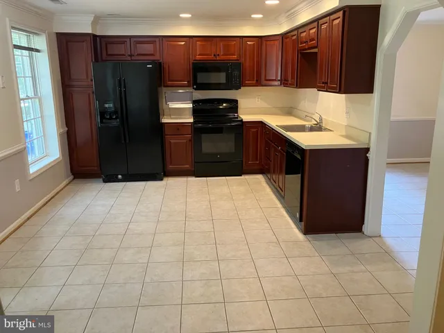 a kitchen with stainless steel appliances a refrigerator and a stove top oven