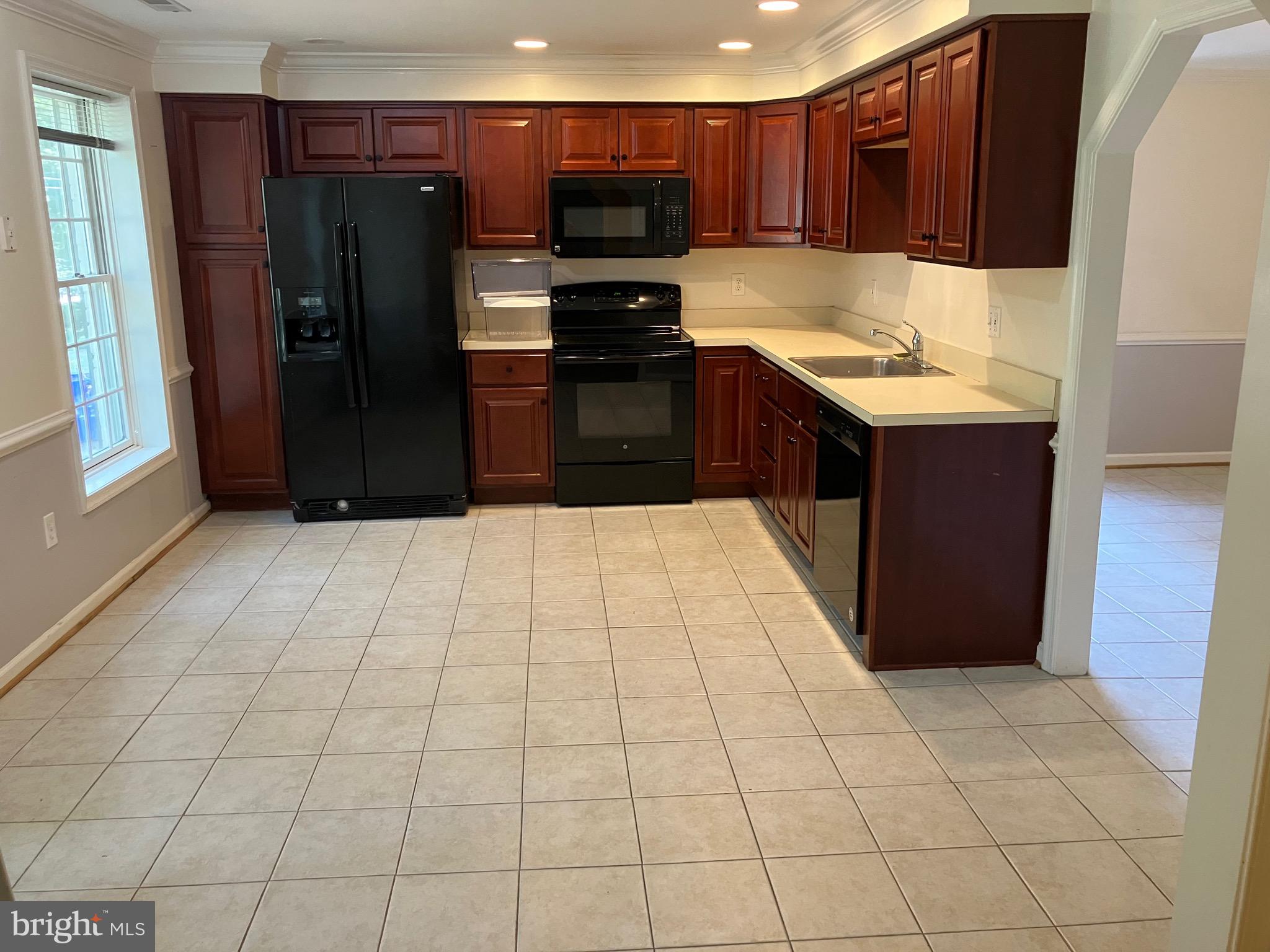 10316 Royal Road Silver Spring, MD 20903 - Photo 10 of 46 a kitchen with stainless steel appliances a refrigerator and a stove top oven