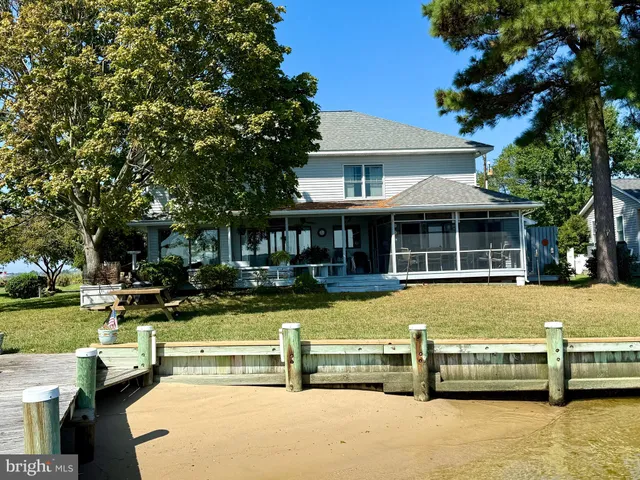 a front view of a house with a yard table and chairs