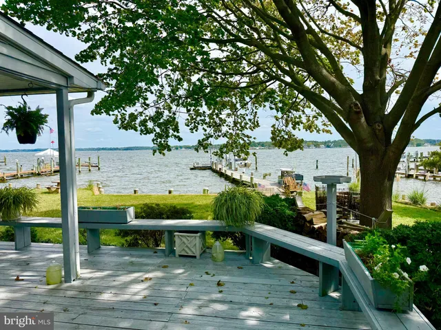 a view of yard from deck with patio
