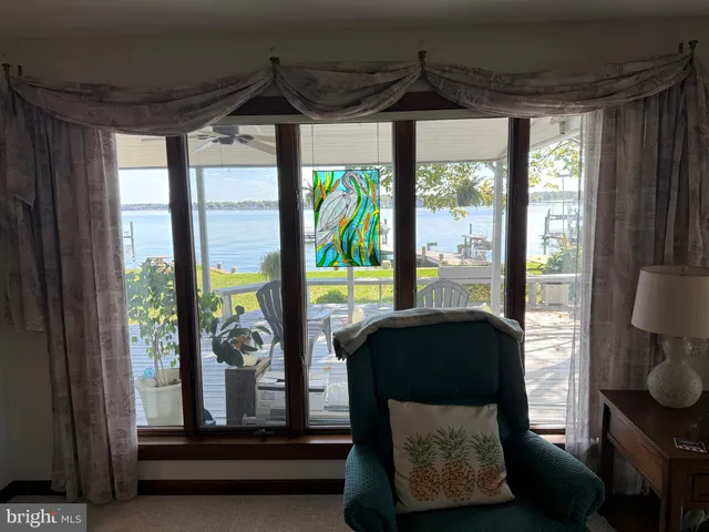 a living room with large window and floor to ceiling window