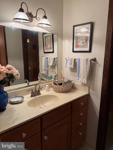 a bathroom with double vanity sinks a vanity and a mirror