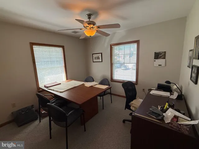 a room with a table chairs and wooden floor