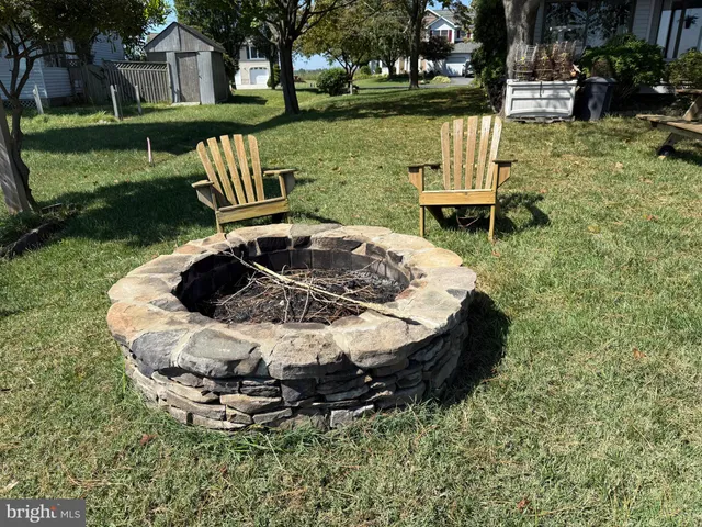a front view of a house with a garden and a chair