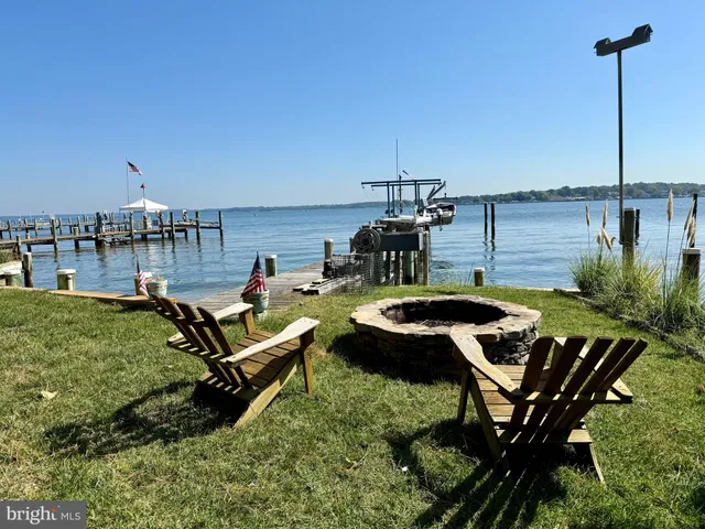 a swimming pool with outdoor seating and yard