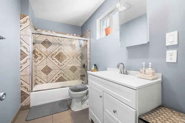 a bathroom with a sink toilet and shower