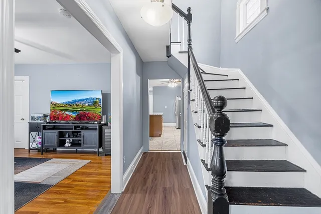 a view of entryway and hall with wooden floor