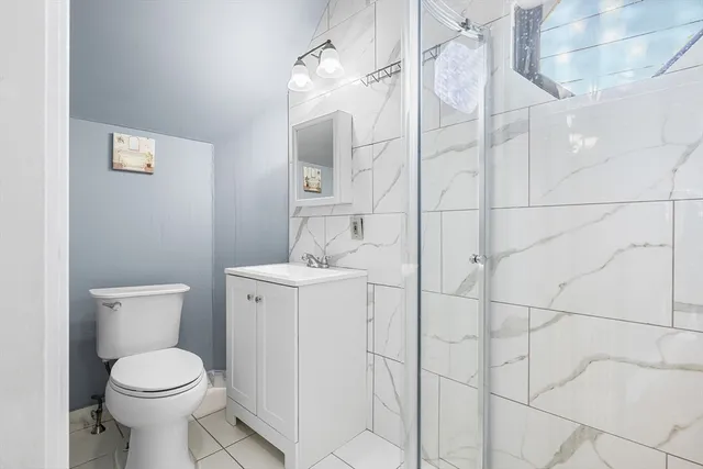 a bathroom with a toilet sink and shower