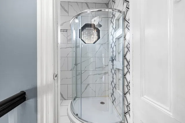 a bathroom with a toilet and shower