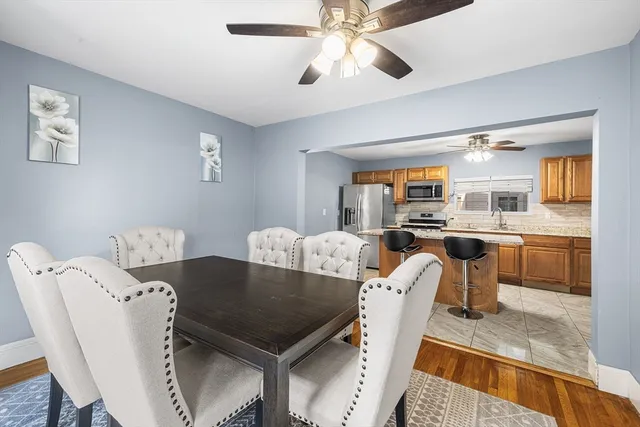 a view of a dining room with furniture and a kitchen