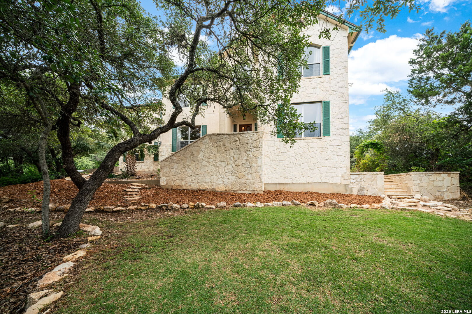 17431 Helotes Spring Road Helotes, TX 78023 - Photo 1 of 50 a view of a white house with a yard