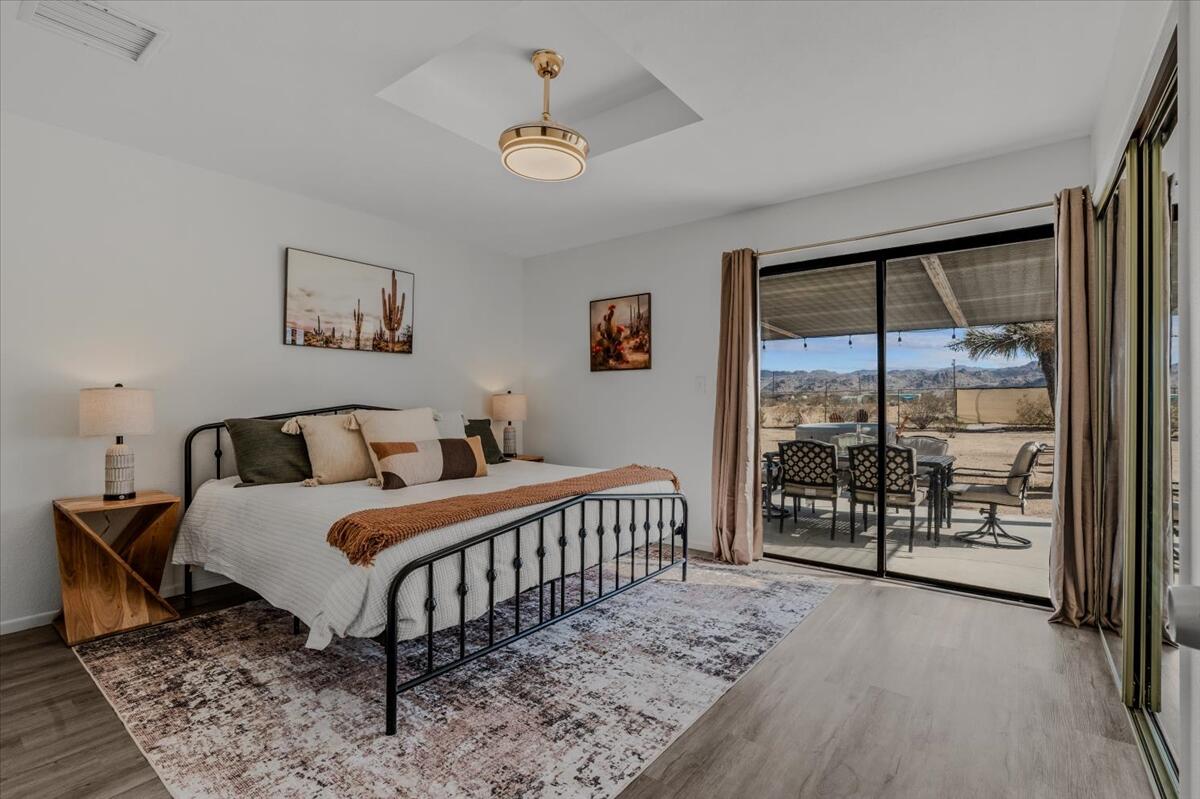 63555 Walpi Drive Joshua Tree, CA 92252 - Photo 13 of 30 a bedroom with a bed and a large window
