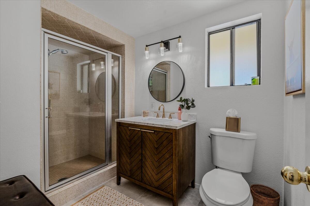 63555 Walpi Drive Joshua Tree, CA 92252 - Photo 18 of 30 a bathroom with a toilet a sink and a mirror