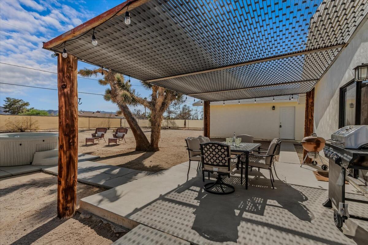 63555 Walpi Drive Joshua Tree, CA 92252 - Photo 22 of 30 a patio with glass top table and chairs